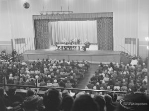 Public meeting on ‘Fair Rents’ bill at Assembly Hall, Barking, showing section of audience and stage with speakers on their feet, 1972