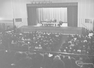 Public meeting on ‘Fair Rents’ bill at Assembly Hall, Barking, showing section of audience and stage with speakers on their feet [possibly including Frank Allaun, MP for Salford East], 1972
