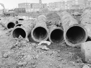 Borough Engineer’s Department clearance of site at Lindsell Road, Barking (Gascoigne 4, Stage 2), showing end-on view of four large pipes, 1972