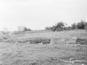 Dagenham Village housing development, showing undeveloped land adjoining east end of Ballards Road, continuing to south-west, with two tower blocks in background, 1972