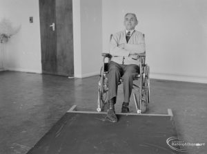 Leys Avenue Occupational Centre for the Physically Handicapped, Dagenham, showing male wheelchair user leaning back with arms folded after pushing over barrier, 1972