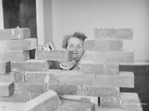 Leys Avenue Occupational Centre for the Physically Handicapped, Dagenham, showing woman building a brick wall, 1972
