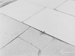 Highways accident, showing broken paving stone near White Horse Public House, High Road, Chadwell Heath, with 2p coin to give sense of scale, 1972