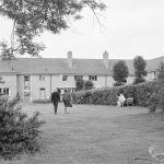 Couple walking into two-storey building [possibly in Barking], 1972