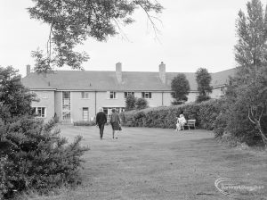 Couple walking into two-storey building [possibly in Barking], 1972