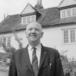 London Borough of Barking Borough Librarian Mr E W McManus FLA outside Valence House and smiling, 1972