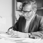 London Borough of Barking Deputy Borough Librarian Mr L Cannon FLA with hands touching, writing at his desk, 1972