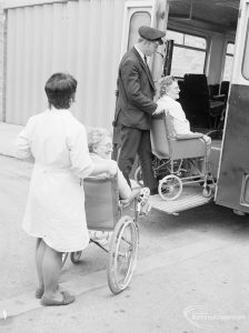 Welfare Department, taken for Social Services Dagenham Town Show display, showing nurse and attendant wheeling passengers into ambulance at Eastbury House, Barking, 1972
