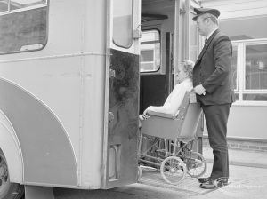 Welfare Department, taken for Social Services Dagenham Town Show display, showing attendant and wheelchair user on ambulance tail-lift at Eastbury House, Barking, 1972