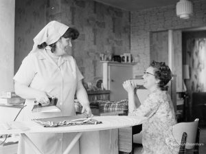 Welfare Department, taken for Social Services Dagenham Town Show display, showing carer ironing for woman in her house, 1972