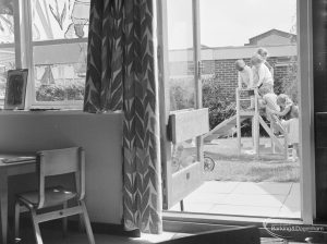 Welfare Department, taken for Social Services Dagenham Town Show display, showing view from indoors of children playing around slide, 1972