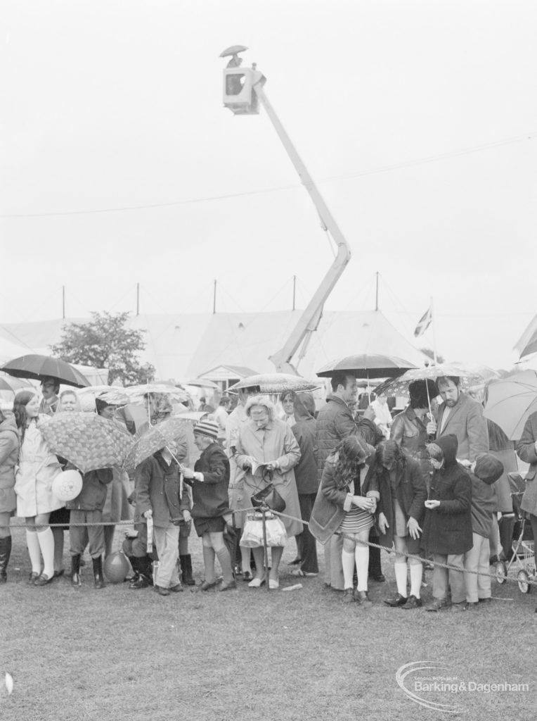Dagenham Town Show 1972 at Central Park, Dagenham, showing Thames Television crew on crane, and crowd with umbrellas, 1972