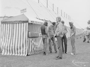 Dagenham Town Show 1972 at Central Park, Dagenham, showing young men standing by closed Hot Dog stand, 1972