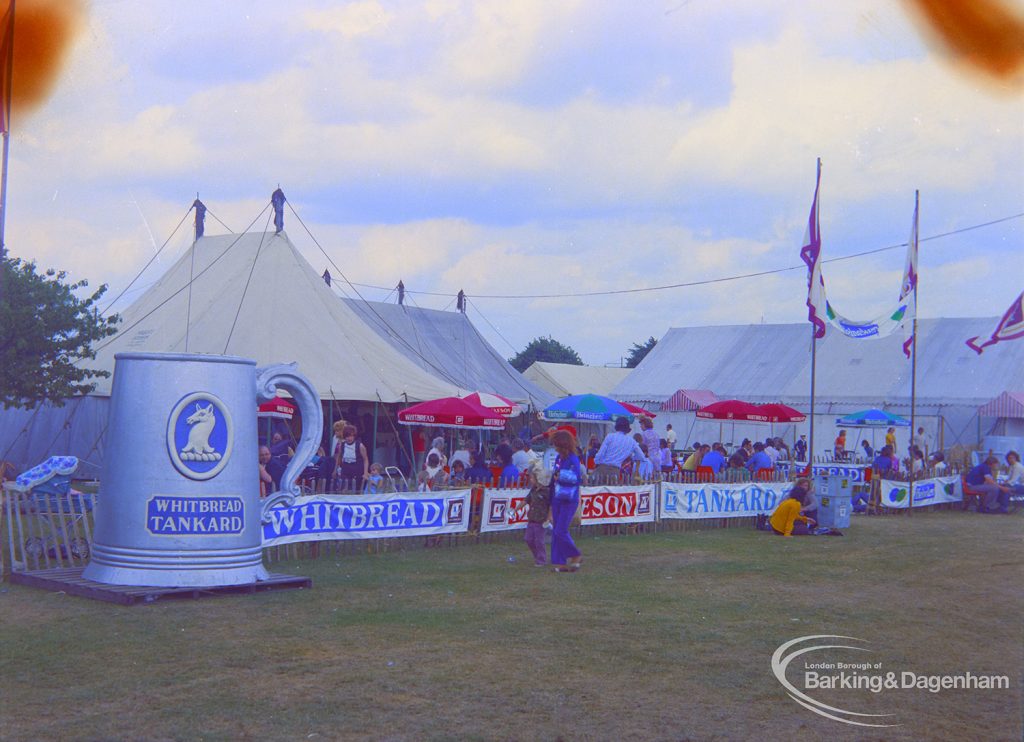 Dagenham Town Show 1973 at Central Park, Dagenham, showing Beer Marquee with visitors sitting and drinking, and large ‘Whitbread Tankard’ and other signs, 1973