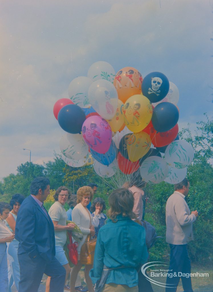 Dagenham Town Show 1973 at Central Park, Dagenham, showing balloon seller by Civic Centre with visitors walking by, 1973