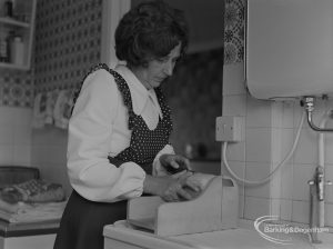 Welfare for the Blind, showing blind woman at home cutting bread, 1973