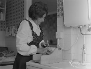 Welfare for the Blind, showing blind woman at home cutting bread, 1973