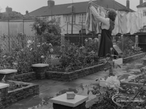 Welfare for the Blind, showing woman hanging out washing to dry, with device in foreground with audible warning when rain is falling, 1973