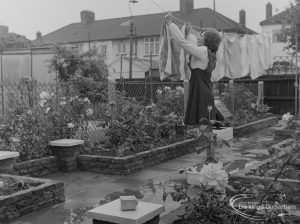 Welfare for the Blind, showing woman hanging out washing to dry, with device in foreground with audible warning when rain is falling, 1973