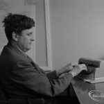 Welfare for the Blind, showing the blind organiser at Aldis House, Barking typing at his desk, 1973