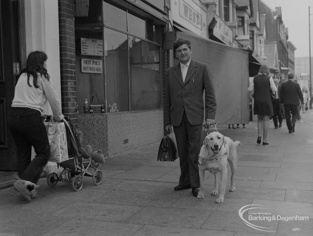 Welfare for the Blind, showing the blind organiser at Aldis House, Barking walking with his guide dog in Ripple Road, 1973