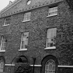 Barking Vicarage, showing front view, pediment only, taken from south amongst trees, 1974