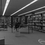 New Barking Central Library, Axe Street, Barking, showing Lending section, central area of bookcases taken from south, 1974