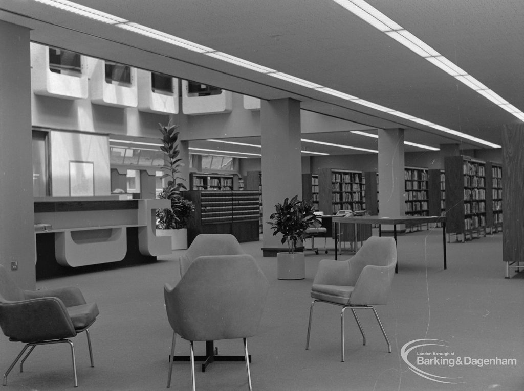 New Barking Central Library, Axe Street, Barking, showing armchairs, bookcases and counter in Lending section, 1974