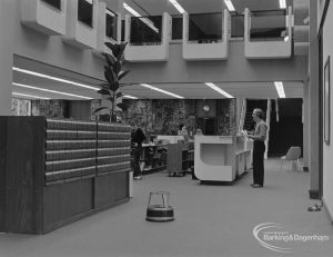 New Barking Central Library, Axe Street, Barking, showing Lending section with catalogue and Mr Leslie Saggers at counter, 1974