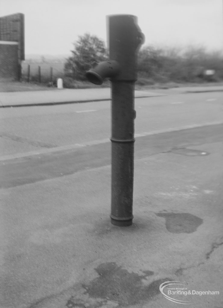 Old iron pump in pavement, east end of High Road, Chadwell Heath, 1976