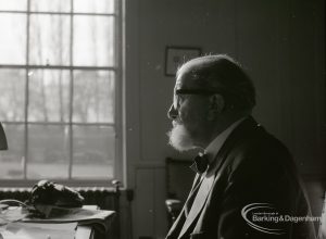 Dagenham Borough Librarian John Gerald O’Leary sitting at desk in study, 2 February 1965