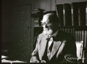 Dagenham Borough Librarian John Gerald O’Leary in study, with rows of books behind him, 2 February 1965