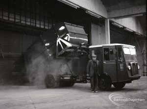 Dagenham Council salvage, showing new type dustcart discharging effluent, with driver standing by, 9 February 1965