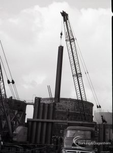 Dagenham Council Sewage banks reconstruction, showing crane lowering pipe, 1965