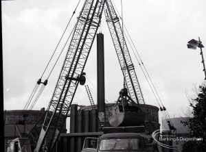 Dagenham Council Sewage banks reconstruction, showing crane, with grab in action, 1965