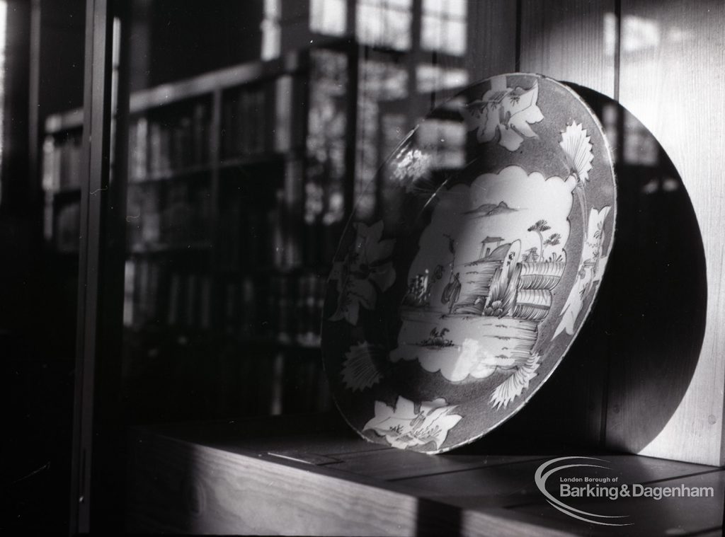 Victoria and Albert exhibition of Delftware pottery at Rectory Library, Dagenham, showing a plate from circa. 1750, 1965