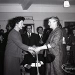 Chairman of Dagenham Council Libraries Committee Alderman Mrs A R Thomas talking to Mrs O’Leary [?], on the occasion of the retirement of Borough Librarian John Gerald O’Leary, and with other guests watching, 1965