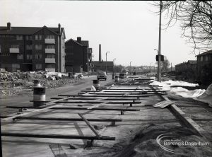 Road construction in Rainham Road South, Dagenham, showing half-constructed section near Madrid Court tower block,1965