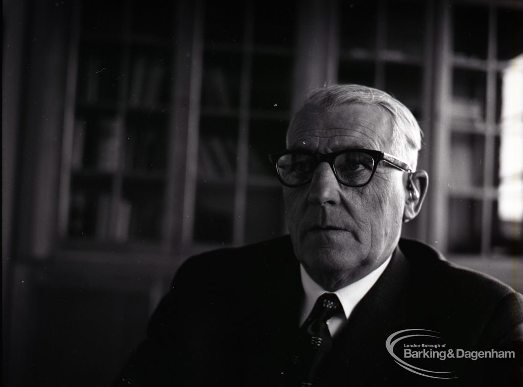 Dagenham Borough Surveyor and Engineer Mr Jack Jones sitting at desk, 1965