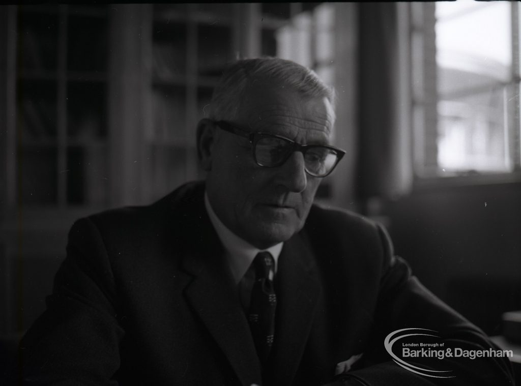 Dagenham Borough Surveyor and Engineer Mr Jack Jones writing at desk, 1965