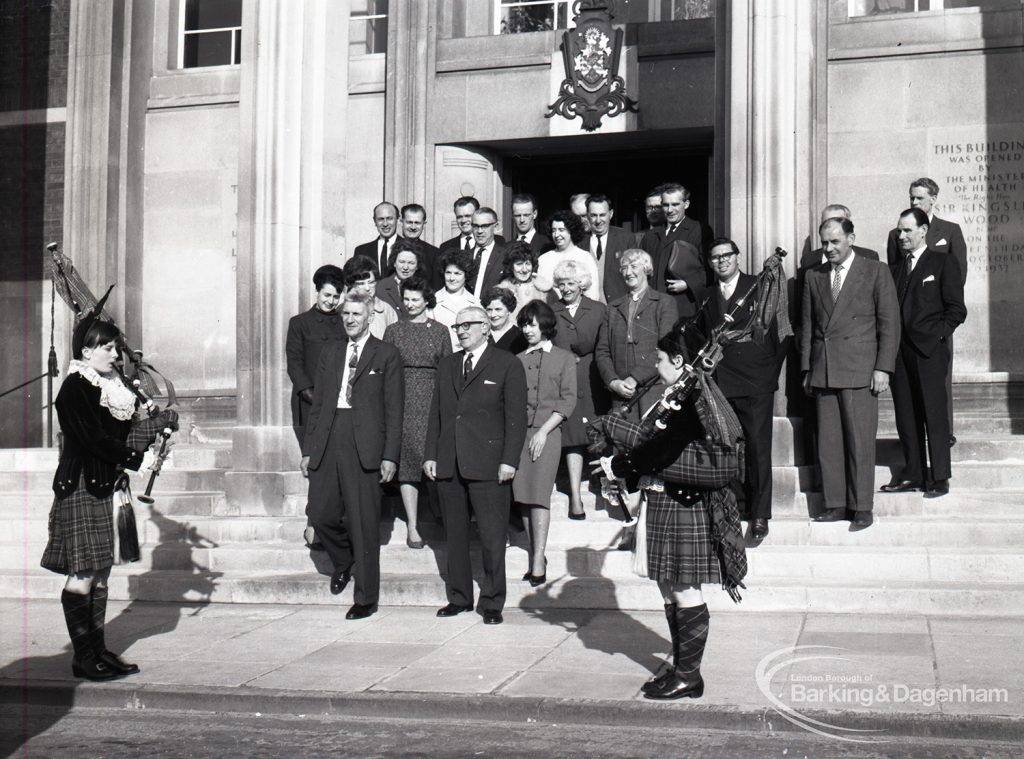 Reception for Dagenham Borough Surveyor and Engineer Mr Jack Jones, showing group of staff on steps of Civic Centre with Dagenham Girl Pipers, 1965