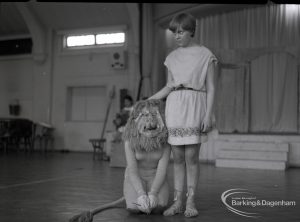 Dagenham Secondary school play, with children performing Androcles and the Lion, showing Androcles standing by kneeling Lion, 1965
