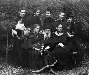 Group of eight people and dog,  Late 19th early 20th Century.