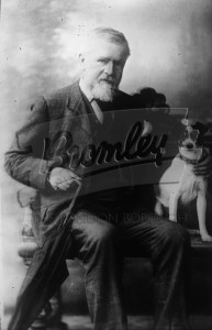 Seated gentleman with dog,  Late 19th early 20th Century.