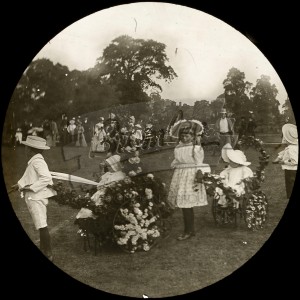 Children at a fete with floral carts, Beckenham 1900s