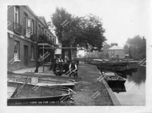 River Lea at Clapton, includes men outside The Jolly Anglers pub, V. Green boat builders, Green's Boat House and possibly Hammond's Cottages, 1884.