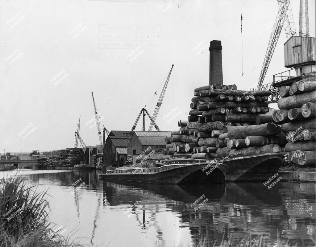 Timber yards and barges on the Hackney Cut, Lea River, north of Homerton Road. 1966.