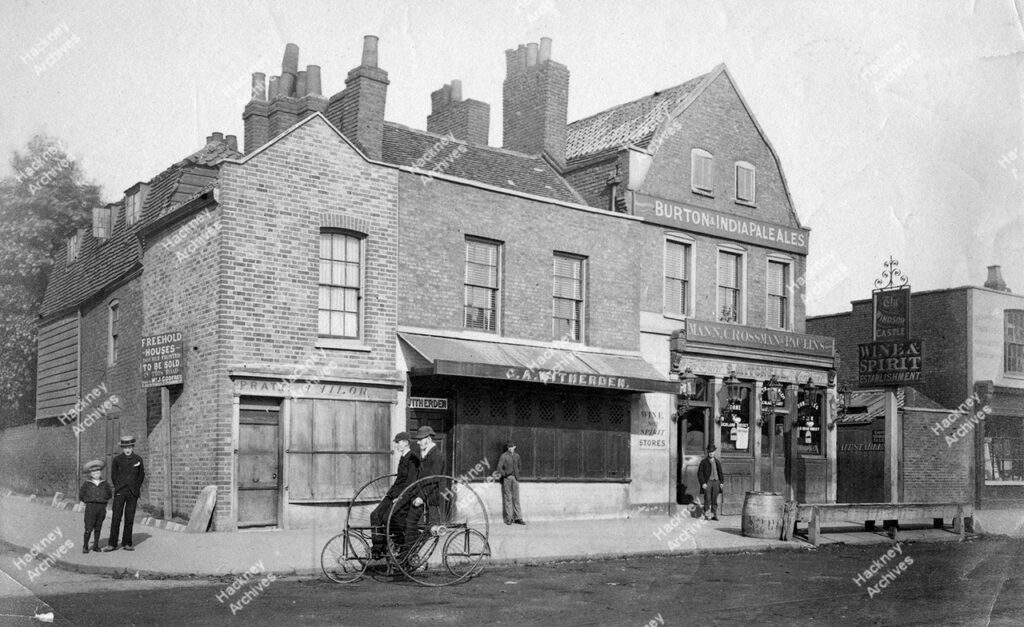 Lower Clapton Road, west side, north of junction with Goulton Road; also showing the Windsor Castle Pub and Men on a Quadracycle. 1884.