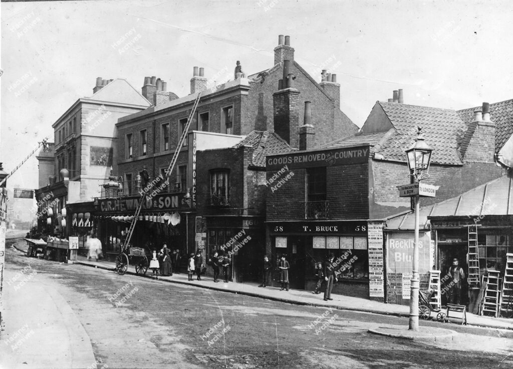 Homerton High Street, Hackney, c.1882. View east from corner of Bridge Street (now Ponsford Street). Includes Locomotive public house, T. Bruce and C. R. Heward & Son.