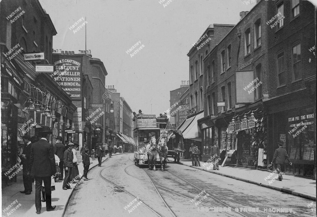 Mare Street, Hackney, looking north to Lower Clapton Road. 1904. Includes Tee To Tum Club on right, John T. Chattaway bookseller, Steam printing works and Corbets. Horse drawn tram.